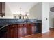 Kitchen with granite counters, dark cabinets, and stainless dishwasher with hardwood floors at 700 Celeste Sw Ln, Atlanta, GA 30331