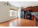Traditional kitchen with dark cabinets, granite counters, and stainless steel appliances, plus a breakfast nook at 700 Celeste Sw Ln, Atlanta, GA 30331