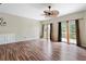 Open-plan living room with wood floors, a ceiling fan, and sliding glass doors to the back deck at 700 Celeste Sw Ln, Atlanta, GA 30331