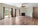 Living room boasts hardwood floors, a fireplace, a ceiling fan, and sliding glass doors to the deck at 700 Celeste Sw Ln, Atlanta, GA 30331