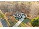 Beautiful home with a long driveway and mature trees in a tranquil setting during a sunny day at 101 Hardwood Ln, Canton, GA 30115