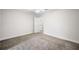 Spacious bedroom featuring neutral walls and carpet with an door to another space at 101 Hardwood Ln, Canton, GA 30115