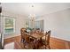 Dining room with wood table, hardwood floors, and natural light from a large window at 101 Hardwood Ln, Canton, GA 30115