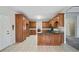 Spacious kitchen featuring wood cabinetry, granite countertops, and tile flooring at 101 Hardwood Ln, Canton, GA 30115