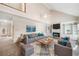 Bright, staged living room featuring a fireplace, built-in shelving, and soaring ceilings at 101 Hardwood Ln, Canton, GA 30115