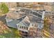 Aerial view of home showing back deck, patio, sun room, mature trees and neutral-colored siding and roof at 101 Hardwood Ln, Canton, GA 30115