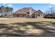 Spacious backyard with a well-maintained lawn, trees, and a home with many windows at 2304 New Haven Pl, Conyers, GA 30094