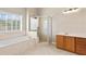 Bright bathroom features a glass enclosed shower, soaking tub, and lots of natural light at 2304 New Haven Pl, Conyers, GA 30094