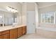 Spacious bathroom with soaking tub, tile floors, and a large vanity with ample counter space at 2304 New Haven Pl, Conyers, GA 30094