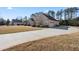 Long concrete driveway leads to a brick home with an attached garage and manicured landscaping at 2304 New Haven Pl, Conyers, GA 30094