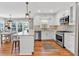 Bright white kitchen featuring a center island, stainless steel appliances, and beautiful hardwood floors at 3623 Summerford Dr, Marietta, GA 30062