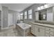 Well-lit bathroom with tile floors, double vanities, soaking tub, and separate shower at 4217 Heisenberg Ln, Suwanee, GA 30024