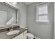 Modern bathroom with vanity, large mirror, and a window providing natural light at 4217 Heisenberg Ln, Suwanee, GA 30024
