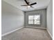 Cozy bedroom with ceiling fan and window, neutrally painted at 4217 Heisenberg Ln, Suwanee, GA 30024