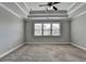 Bright and airy bedroom features neutral walls, soft carpet, tray ceiling, and plenty of natural light at 4217 Heisenberg Ln, Suwanee, GA 30024