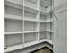 A spacious walk-in closet provides abundant shelving and storage space for an organized wardrobe at 4217 Heisenberg Ln, Suwanee, GA 30024