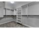 Spacious walk-in closet with multiple shelves and hanging rods for optimal storage at 4217 Heisenberg Ln, Suwanee, GA 30024