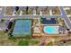 Aerial view of community pool and tennis courts with lush green landscaping, parking and playground at 4217 Heisenberg Ln, Suwanee, GA 30024