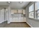 Open floor plan dining area with built-in cabinets and granite countertops at 4217 Heisenberg Ln, Suwanee, GA 30024