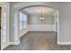 Elegant dining room with wainscoting, chandelier, and hardwood flooring at 4217 Heisenberg Ln, Suwanee, GA 30024