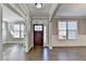 Warm and inviting entryway with hardwood floors and a view into adjoining rooms at 4217 Heisenberg Ln, Suwanee, GA 30024
