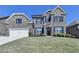 Charming two-story brick home with blue shutters and a well-manicured lawn at 4217 Heisenberg Ln, Suwanee, GA 30024