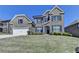 Two-story brick home with attached garage, blue shutters, and manicured landscaping at 4217 Heisenberg Ln, Suwanee, GA 30024