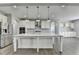 Bright kitchen boasts a large center island with granite countertops and stainless steel appliances at 4217 Heisenberg Ln, Suwanee, GA 30024