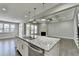 Spacious kitchen island open to the living room with a fireplace at 4217 Heisenberg Ln, Suwanee, GA 30024