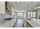 Gourmet kitchen with large island, stainless appliances, and tile backsplash at 4217 Heisenberg Ln, Suwanee, GA 30024