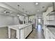 Modern kitchen with large island open to the living space and staircase at 4217 Heisenberg Ln, Suwanee, GA 30024