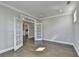 Elegant living room with hardwood floors, neutral paint, and glass paneled french doors at 4217 Heisenberg Ln, Suwanee, GA 30024