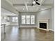Open living area with fireplace, hardwood floors, and views of the kitchen at 4217 Heisenberg Ln, Suwanee, GA 30024