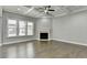 Comfortable living room showcasing a fireplace, hardwood floors, and bright natural light at 4217 Heisenberg Ln, Suwanee, GA 30024