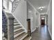 Elegant staircase with wood steps, iron railing, and natural light from windows at 4217 Heisenberg Ln, Suwanee, GA 30024