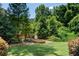 Relaxing backyard with a stone fire pit surrounded by lush greenery, ideal for outdoor gatherings at 4520 Garmon Nw Rd, Atlanta, GA 30327