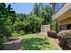 Serene backyard with a stone fire pit and a decorative waterfall feature, set against a backdrop of trees at 4520 Garmon Nw Rd, Atlanta, GA 30327