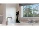 Close up of a stylish bathroom faucet and accessories next to a window with a view at 4520 Garmon Nw Rd, Atlanta, GA 30327