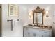Charming bathroom featuring a decorative mirror, updated vanity and modern fixtures at 4520 Garmon Nw Rd, Atlanta, GA 30327