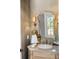 Elegant powder room with decorative mirror, stylish lighting, and sophisticated wallpaper at 4520 Garmon Nw Rd, Atlanta, GA 30327