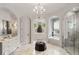 Elegant bathroom with marble floors, dual vanities, arched doorways, and a glass-enclosed shower at 4520 Garmon Nw Rd, Atlanta, GA 30327