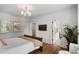 Bright bedroom with hardwood floors, soft natural light, and ensuite bathroom access at 4520 Garmon Nw Rd, Atlanta, GA 30327