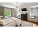 Bright bedroom featuring two window seats, a TV, and sleek modern lighting at 4520 Garmon Nw Rd, Atlanta, GA 30327