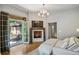 Bedroom with a fireplace, balcony access, and seating area with large windows and hardwood floors at 4520 Garmon Nw Rd, Atlanta, GA 30327