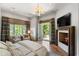 Bright bedroom with a fireplace, TV, balcony access, and seating area with large windows at 4520 Garmon Nw Rd, Atlanta, GA 30327