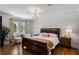 Spacious bedroom featuring a large window, hardwood floors, and an elegant chandelier at 4520 Garmon Nw Rd, Atlanta, GA 30327