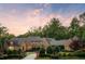 Elegant brick home with wrought iron fence, lush landscaping, and circular drive at 4520 Garmon Nw Rd, Atlanta, GA 30327