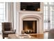 Close up of the fireplace with a stone mantel, herringbone pattern inside, and view of the backyard at 4520 Garmon Nw Rd, Atlanta, GA 30327