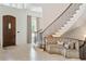 Bright foyer featuring a custom wood door, staircase with iron railing, and built-in bench seating at 4520 Garmon Nw Rd, Atlanta, GA 30327