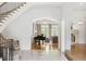 Grand foyer featuring a curved staircase, piano, and arched doorways to other rooms at 4520 Garmon Nw Rd, Atlanta, GA 30327
